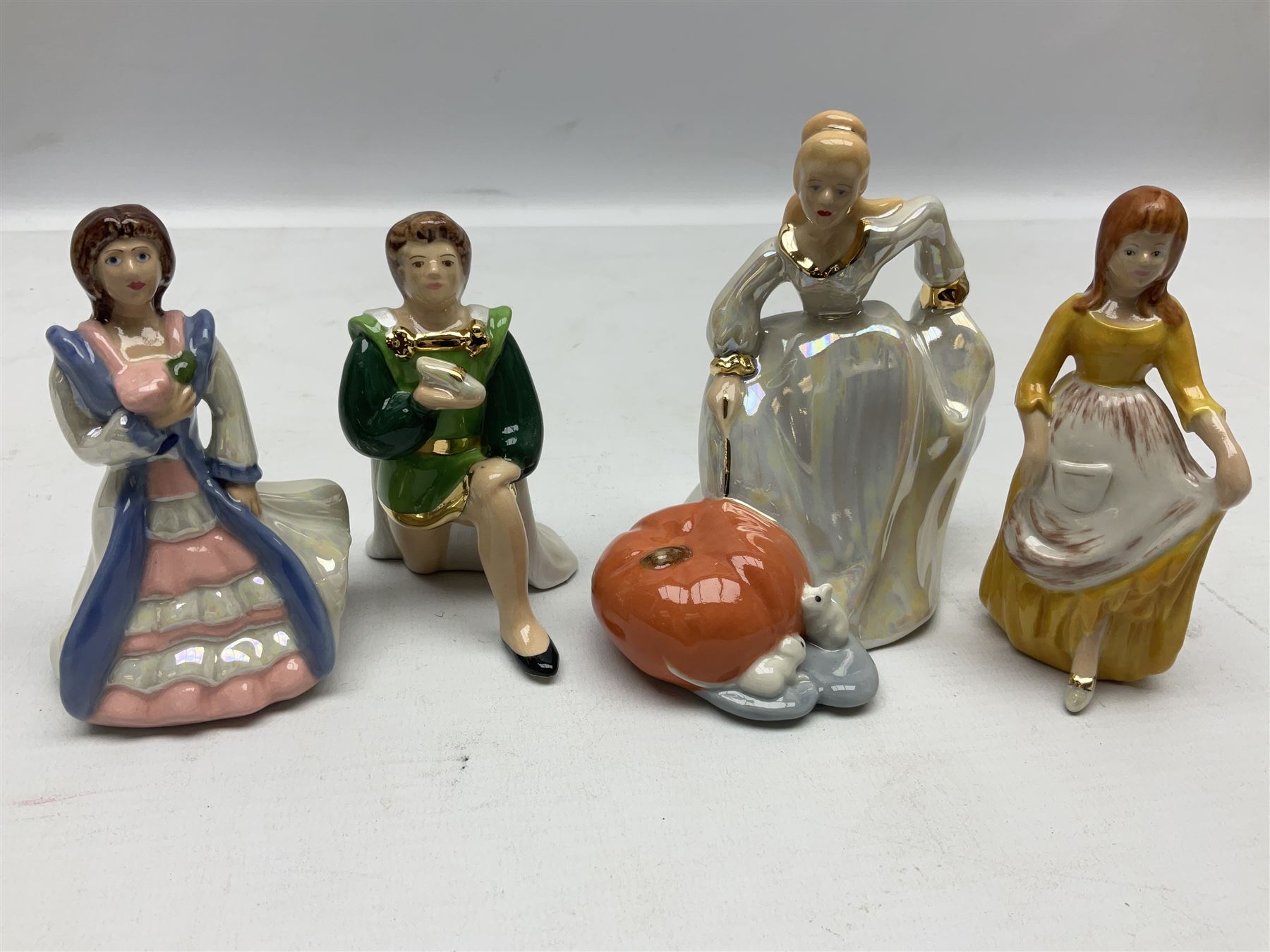 Thirteen Wade Collectors Club figures, comprising six Alice in Wonderland figures; Queen of Hearts, Alice, Mad Hatter, The Doormouse, White Rabbit and Cheshire cat, six Cinderella figures; Fairy Godmother, Cinderella Ready for the Ball, Prince Charming, Cinderella, Clorinda and Thisbe, together with Beauty from Beauty and the Beast, all with original boxes  