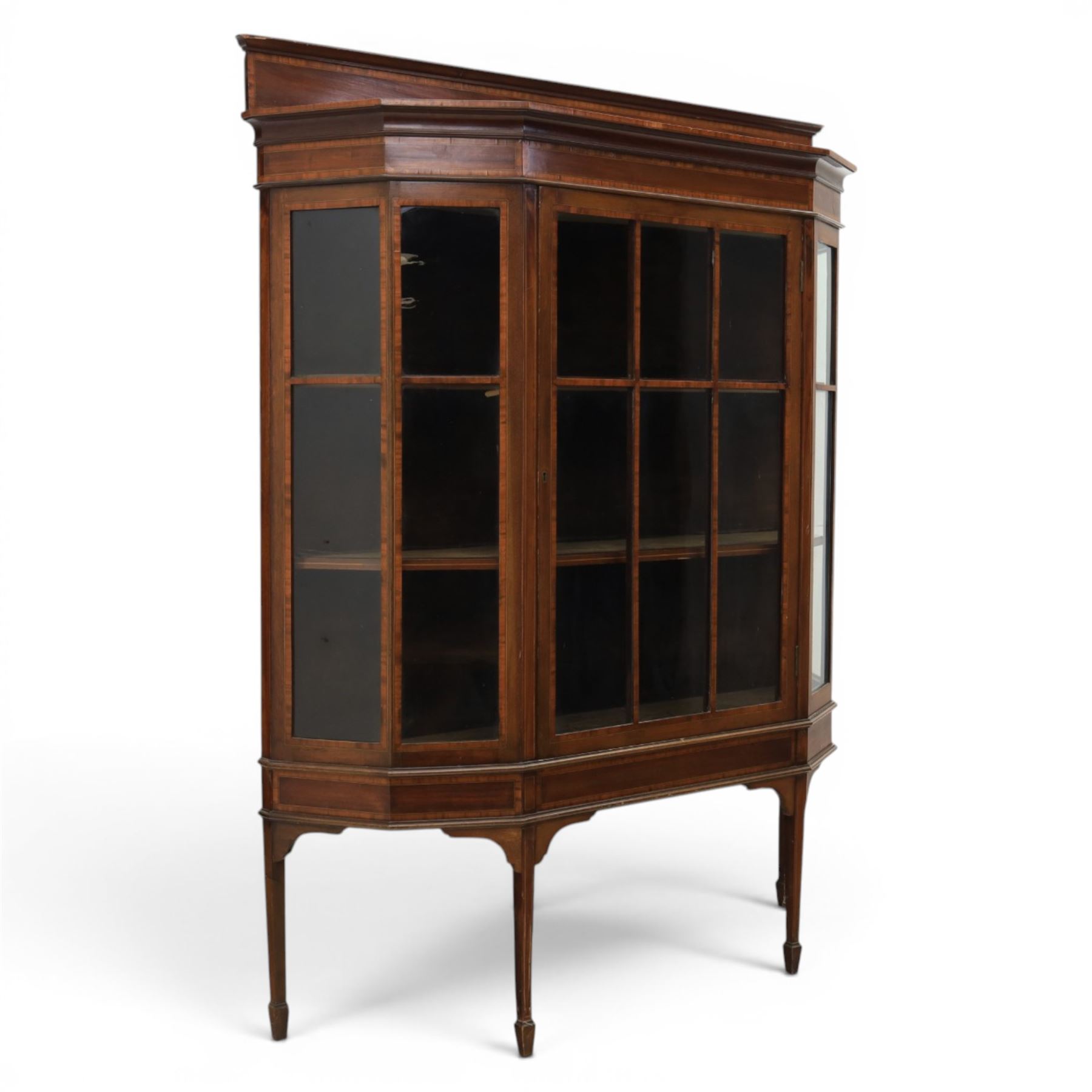 Edwardian inlaid mahogany display cabinet of rectangular canted form, galleried top with crossbanded inlay, above a glazed cabinet enclosing  baize lined shelves, raised on square tapering legs terminating in spade feet  