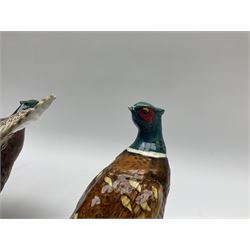 A collection of Beswick figures, comprising ginger cat model no 1898, ginger Persian kitten model no 1886, pheasant in flight model no 849, and pheasant model no 1226b.  
