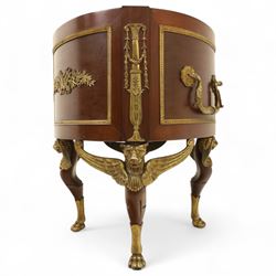 An imposing and richly adorned Empire Revival jardiniere of circular form, decorated with finely cast gilt bronze laurel garlands and floral swags, interior with a modern brass liner, sides with gilt bronze carrying handles, raised on three tripod legs with classical caryatid masks with wings terminating in lion paw feet, circa 1900

Provenance: This jardiniere formed part of the original furnishings of the opulent Empire Room at Kinloch Castle, built by industrialist George Bullough in 1900.

An original inventory number, ‘X954’, is inscribed on one facing, verifying its presence in the Kinloch Castle collection. This jardiniere epitomises the lavish taste of the Edwardian elite and the high standards of craftsmanship employed in the furnishing of Kinloch Castle, the first private home in Scotland to be lit by electricity and famed for its extravagant interiors.


