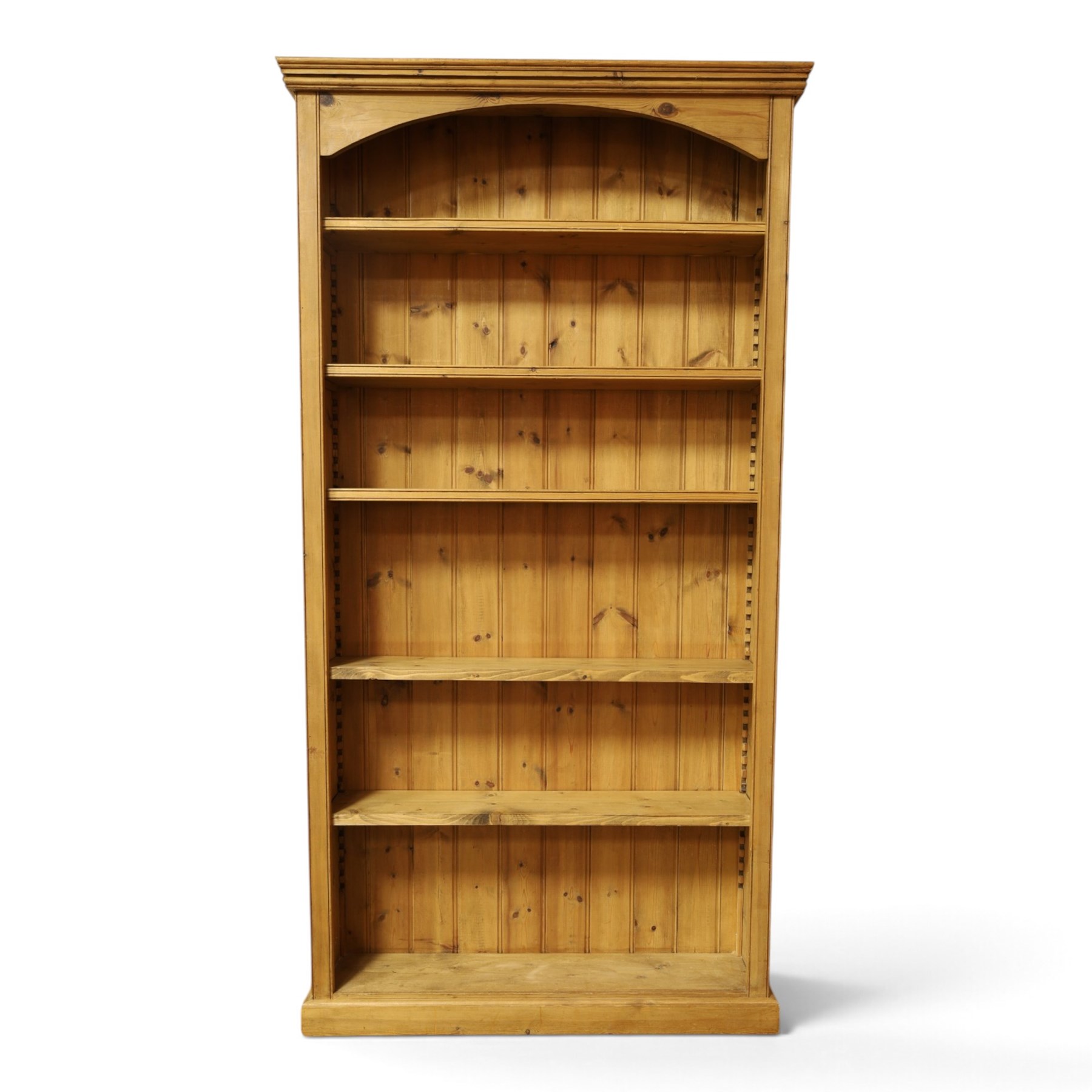 Traditional large pine bookcase, moulded cornice above five adjustable shelves