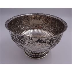 Late Victorian silver rose bowl, of circular form with embossed foliate and C scroll decoration, and engraved personal dedication, upon a part fluted spreading circular foot, hallmarked Wakely & Wheeler, London 1898, H11.5cm D18cm, approximate weight 11.67 ozt (363.2 grams)