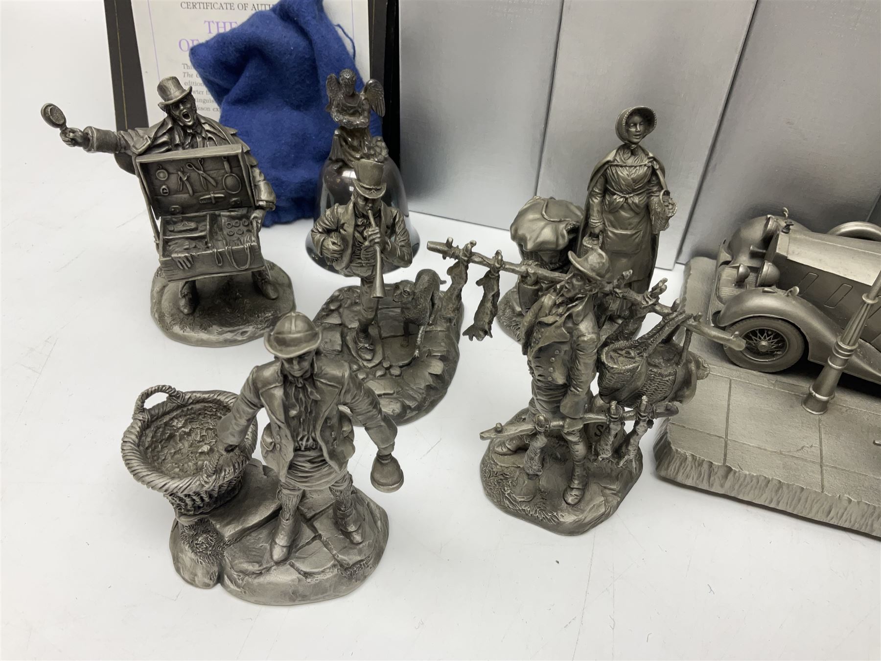 Twelve Franklin Mint pewter figures, to include some from the Cries of London series, together with a Franklin Mint 1937 Rolls Royce Phantom III pewter model and Danbury Mint Christmas bells