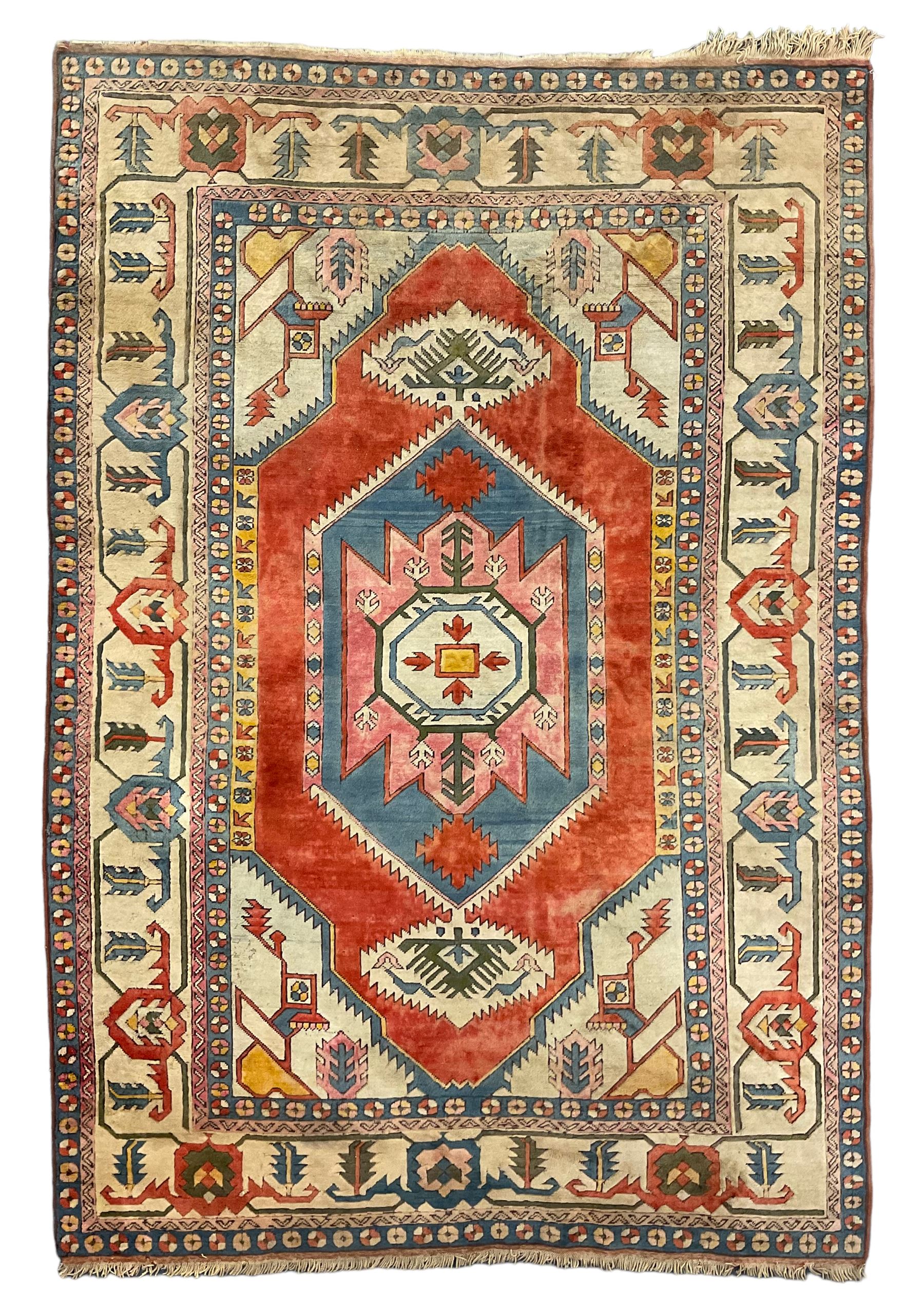 Anatolian Turkish ivory ground carpet, the central geometric pole medallion within an amber field, the guarded border decorated with stylised plant motifs surrounded by bands of repeating flower heads