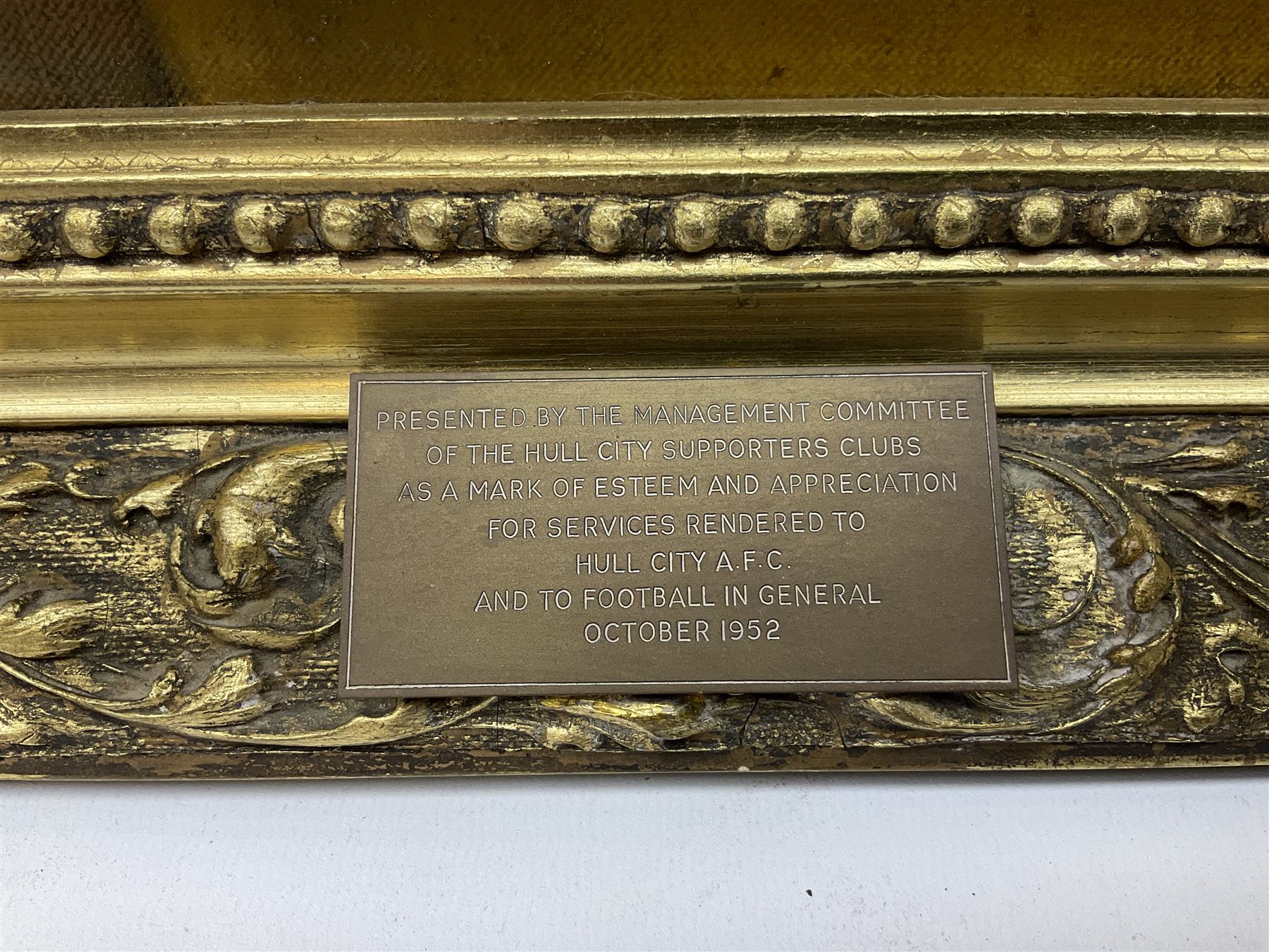 Roland F. Spencer Ford (1902 - 1990), oil painting on canvas, half length portrait of Raich Carter, standing dressed in Hull City kit, the Hull town crest in the background surrounded by the names Hull City A.F.C., Sunderland, Derby County and England, bears label verso from the studio of the artist in Newstead Street, Hull with original price of £75, signed, 59.5 x 49.5cm, gilt frame with metal plaque inscribed ' Presented by the Management Committee/of the Hull City Supporters Clubs/as a mark of esteem and appreciation/for services rendered to/Hull City A.F.C./and to football in general/October 1952'. Provenance: By direct descent from the family of Raich Carter having been consigned by his daughter Jane Carter.