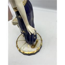 Royal Dux Art Deco figure group of Turkish dancing girl with a young boy beside her holding a casket, decorated with gilding, raised upon scalloped edge plinth base, with applied pink triangle and impressed 2948 beneath