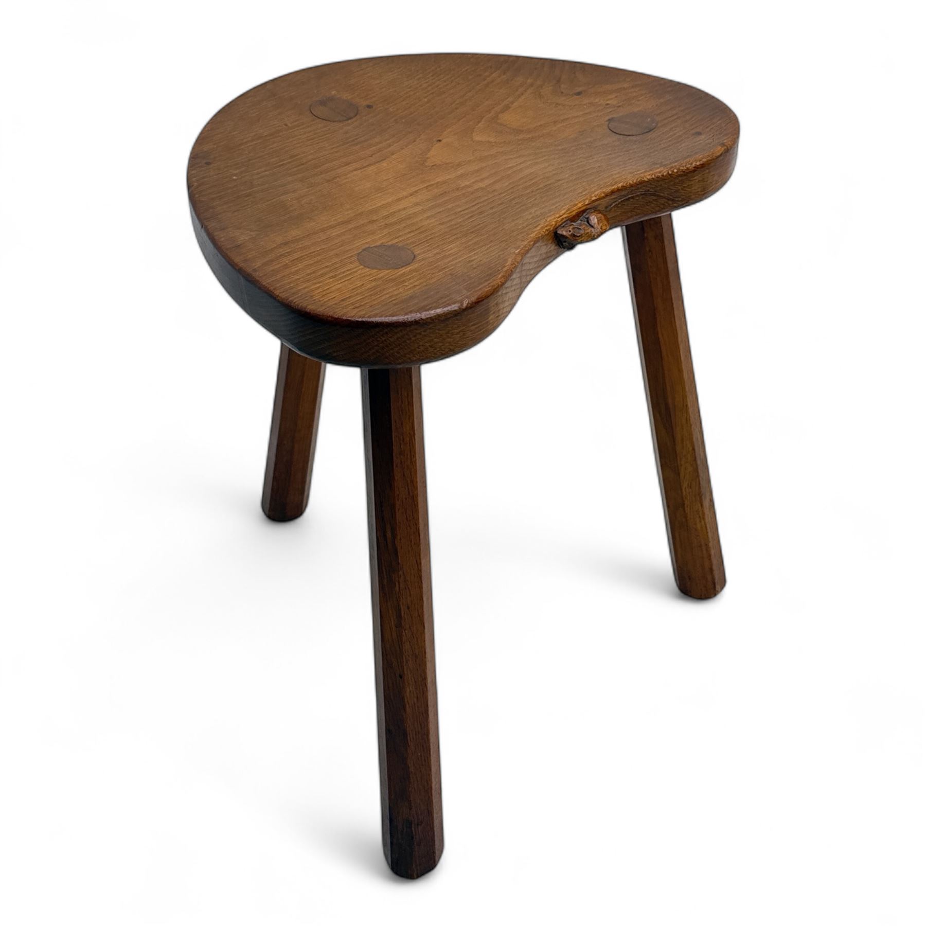 Mouseman - oak three-legged cow stool, kidney-shaped seat carved with the signature mouse motif, by the workshop of Robert Thompson, Kilburn
