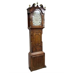 A mid-19th century oak and mahogany longcase clock by “ Wm Harrison, Tadcaster”, swans neck pediment with brass paterae and three ball and spire finials, recessed break arch door flanked by two turned and ringed pillars with brass capitals, oak and mahogany trunk with a short door and twin spire top and inlaid crosbanding, on a conforming rectangular plinth with a raised panel, fully painted break arch dial with a depiction of a traveller in a continental landscape to the arch, with floral painted spandrels, Roman numerals and fifteen minute Arabic's, subsidiary seconds dial and date calendar, matching hands in stamped brass, dial pinned directly to an eight day rack striking movement, striking the hours on a bell. With pendulum, weights and key.         
William Harrison is recorded as working at various locations in Tadcaster during the 19th century, High Street (1822) Bridge Street (1826) and Kirkgate (1832). 


