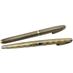 Sheaffer Imperial Sovereign fountain pen, the14K rolled gold body with diamond effect, and nib marked 14K, together with another similar Sheaffer fountain pen, with textured gold and silver coloured body, and nib marked 14K, (2)