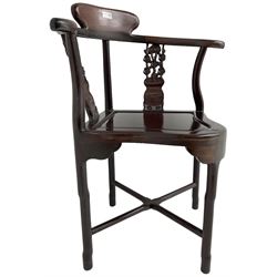 Chinese carved hardwood corner chair, outswept arms over pierced and carved floral splats, raised on shaped cylindrical supports united by X-stretcher