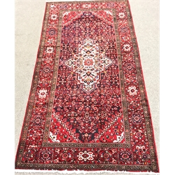 Hamadan red ground rug, repeating border, central medallion, 325cm x 170cm