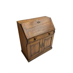 19th century waxed pine bureau, the fall front opening to reveal fitted interior with two drawers and five pigeonholes, base with single drawer over two panelled cupboard doors, on plinth base