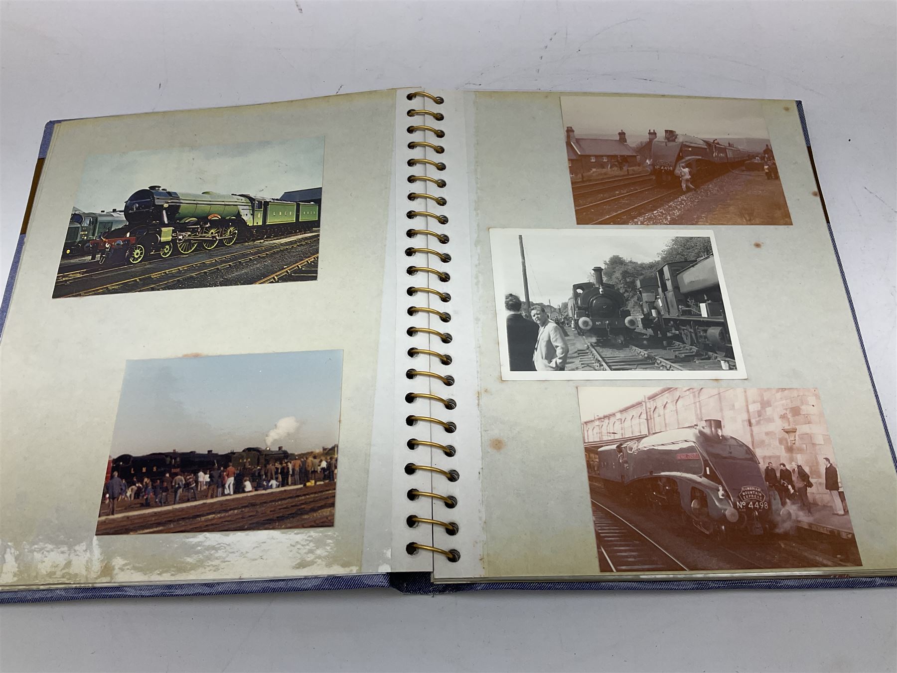Black painted three colour railway lamp with revolving filters, H29cm; BR Acme Thunderer whistle; three railway peaked caps, two with BR Intercity 125 badge; small album of photographs of railway interest etc