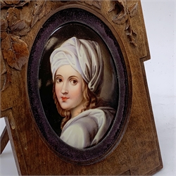 19th century KPM style oval porcelain plaque, painted with a portrait of Beatrice Cenci after Guido Reni, signed verso s.l.n?, in Continental walnut shaped frame with Rose carved crest and easel style support verso, plaque 13cm, frame H25.5cm  