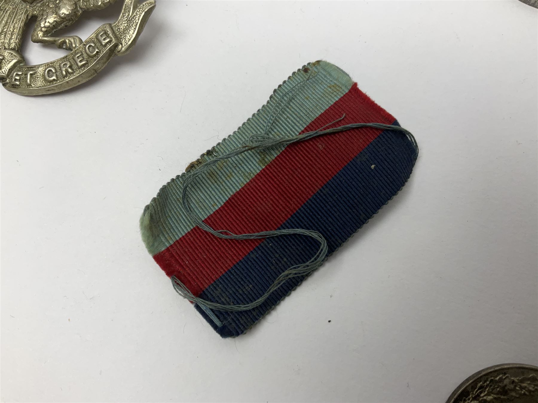 WW1 pair of medals awarded to 151761 Gnr. S. Loten R.A. with ribbons; four WW2 medals with ribbons; and small quantity of cap badges, medallions etc