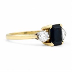 18ct gold sapphire and diamond three stone ring, single octagonal cut sapphire of approx 0.90 carat, with a round brilliant cut diamond set either side, London 1996, total diamond weight approx 0.30 carat