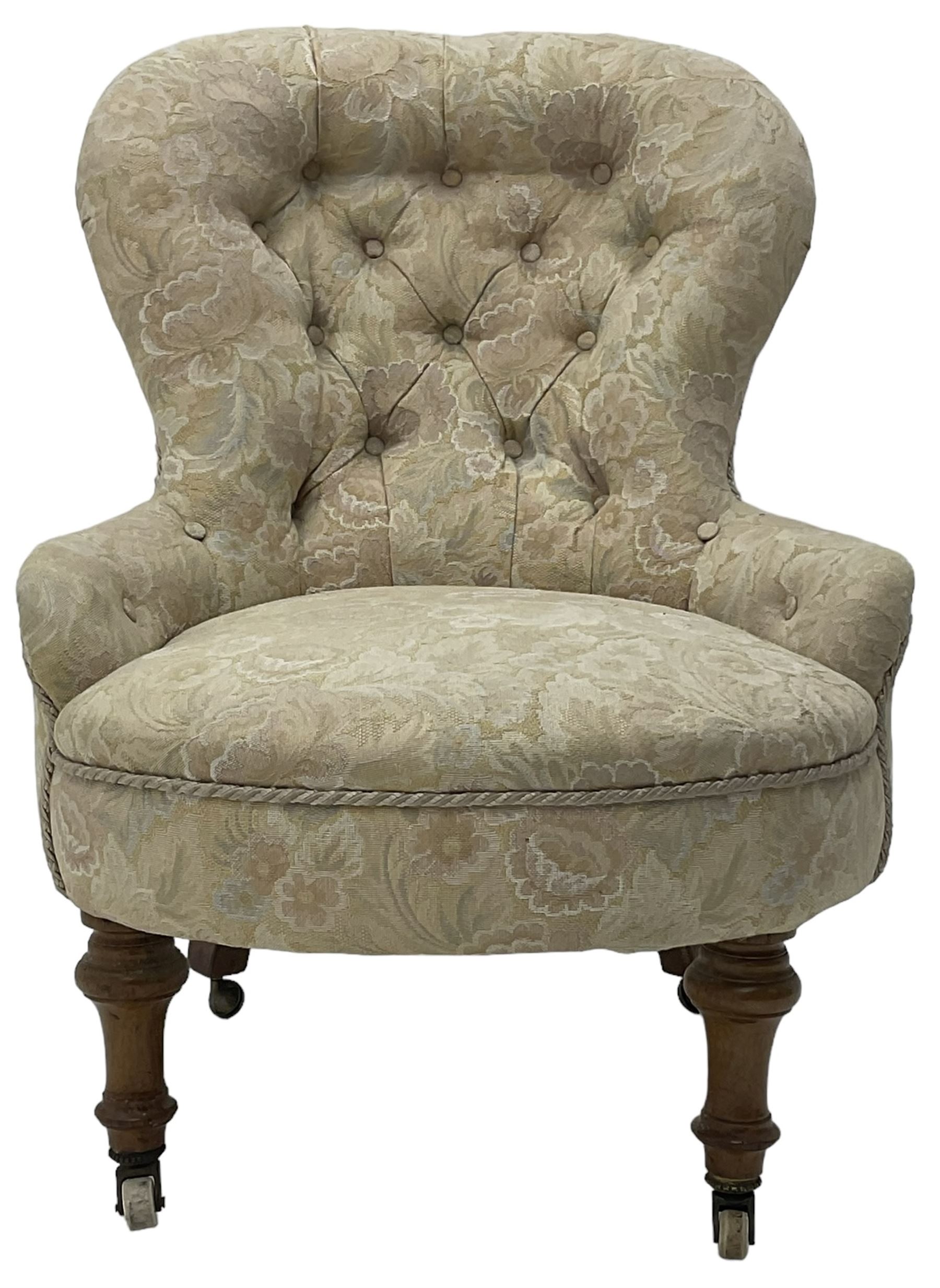 Victorian walnut framed nursing chair, upholstered in buttoned floral pattern fabric, on turned front feet 