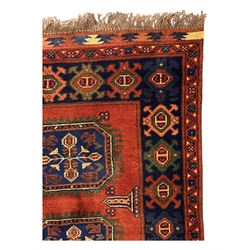 Late 20th century Afghan style ground runner, woven with a repeating panel design along a terracotta field and indigo grounds, framed by multiple narrow borders, and finished with fringed ends