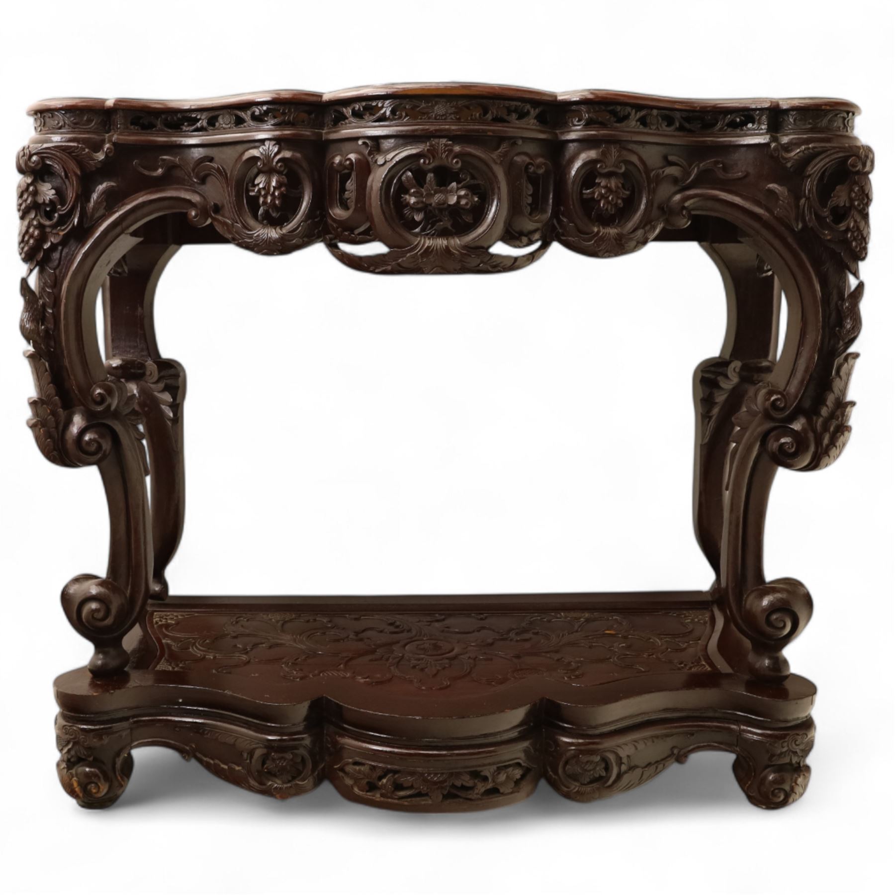 Chinese stained hardwood side table, late Qing dynasty style, with shaped top above a pierced and carved frieze of foliage and fruiting vines, cabriole legs terminating in scroll feet, united by a carved shaped undertier