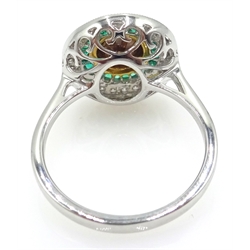  18ct white gold emerald, white and yellow diamond circular ring, stamped 750, central diamond approx 1 carat   