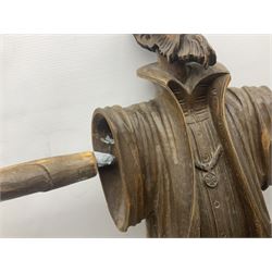 Spanish carved figure of Don Quixote, holding a book, base stamped 'Ouro, together with two spelter figures and one other