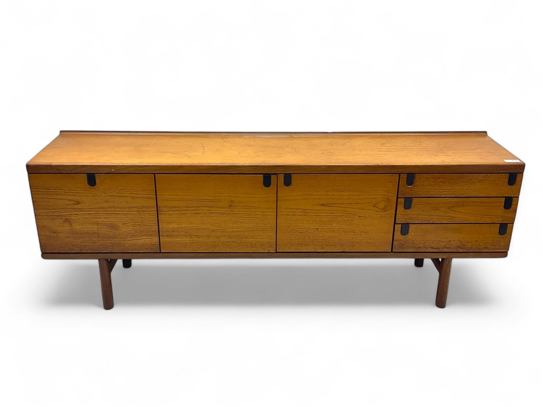 White & Newton - mid-20th century teak sideboard, rectangular top with raised back over fall-front storage compartment, double cupboard and three drawers, raised on cylindrical supports