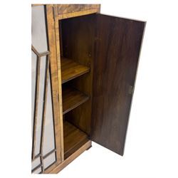 Art Deco burr walnut drinks cabinet, geometric central glazed astragal door enclosing two fixed shelves, flanked by symmetrical bookmatched veneered cupboards with drawers above 