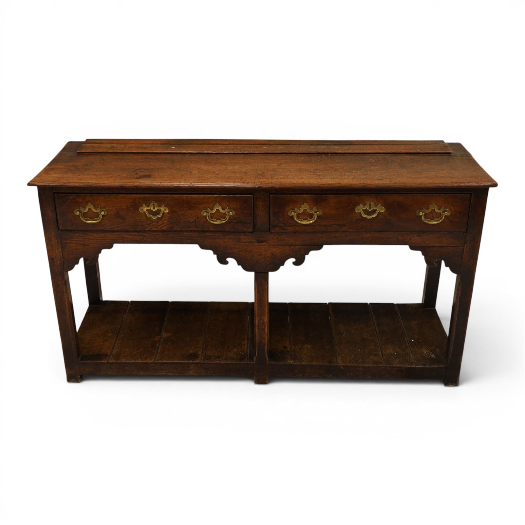 George III oak dresser base, rectangular top with moulded edge, fitted with two drawers over shaped spandrels, raised on square chamfered supports united by undertier, on stile feet