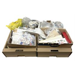 Mixed stamps, mostly loose on pieces and off paper, in two boxes