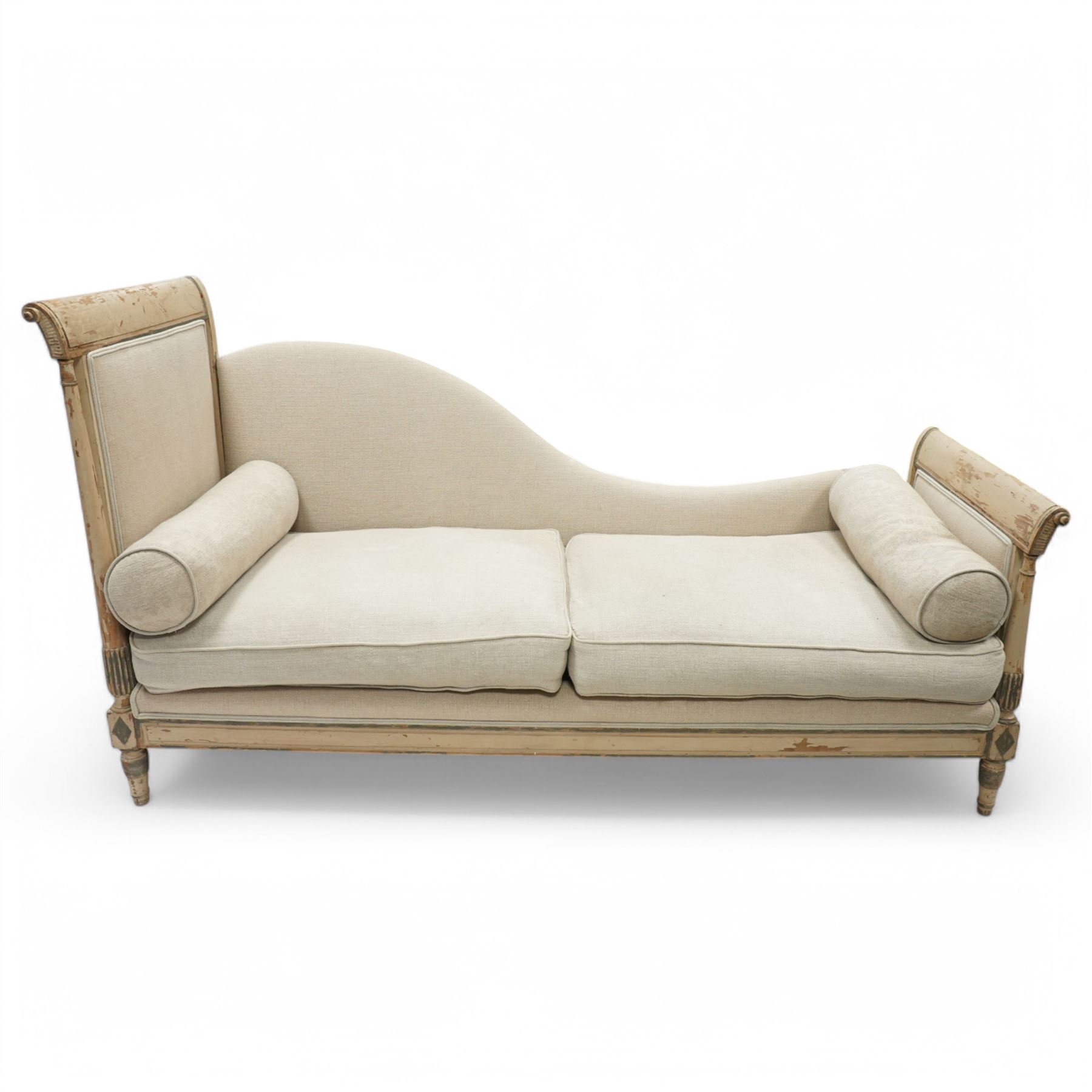 19th Century French day bed, the shaped back and scroll ends with fluted supports and carved rosettes, upholstered in natural linen with loose seat cushions and bolster pillows