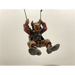 Painted wooden hanging model of a hot air balloon group, the balloon above a wicker basket complete with sandbags and figures, together with a similar example with a clown figure below, H68cm