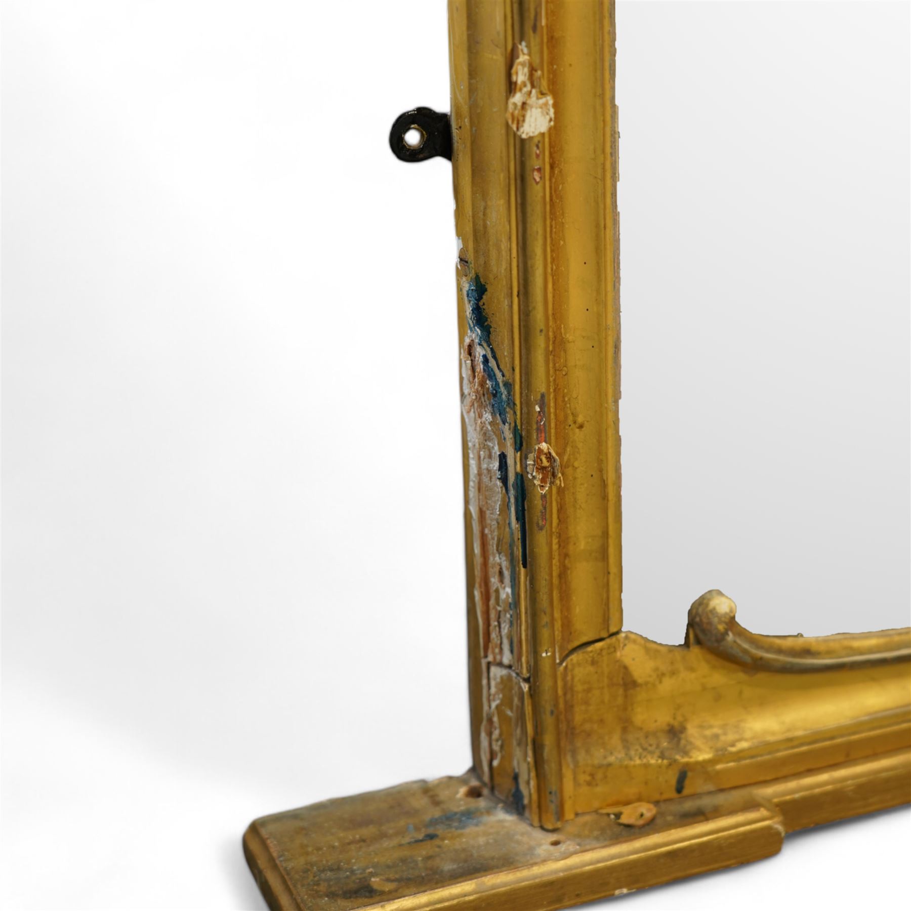 Large Victorian gilt wood overmantle mirror, shaped cresting rail with curled acanthus leaf pediment, the corners decorated with foliate C-scrolls and flower heads, curled foliage lower corner brackets, plain mirror plate 