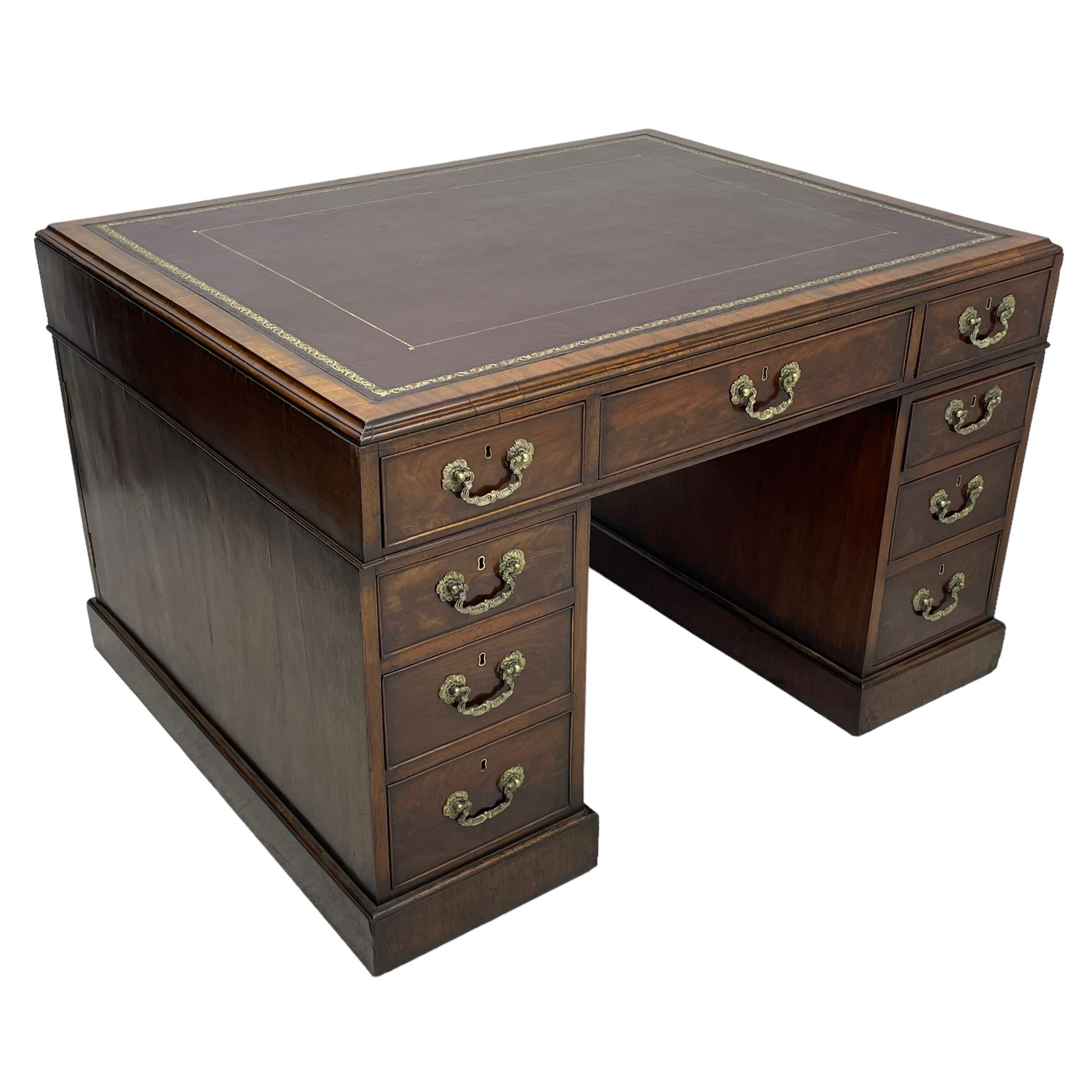 George III mahogany twin pedestal partner's desk, moulded rectangular caddy top with tooled leather inset, one side fitted with nine drawers and the opposing side fitted with single drawer, two false drawers and two panelled cupboards, ornate cast gilt metal handles and handle plates, on plinth base