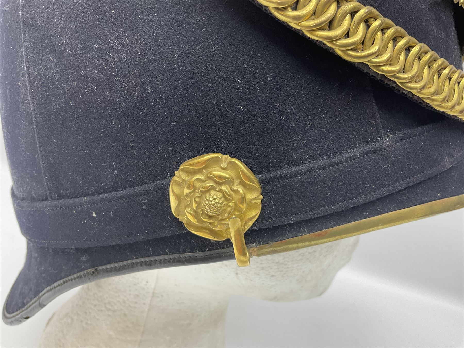 Post-1902 Welsh Regiment Officer's Home Service Blue Cloth Helmet with gilt metal King's crown helmet plate to the front, a removable spike to the top on a shaped cruciform base with rosette fittings, rosette side bosses, brass trim to the front peak, and leather and velvet backed chin scales, with sweat band, the interior with the remains of a makers label at the address 1,3 & 5 Lexington Street, Golden ? London W (presumably Hobson & Sons)