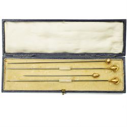 Four early 20th century 9ct gold mounted hat pins including an acorn, ball and cased pair ...