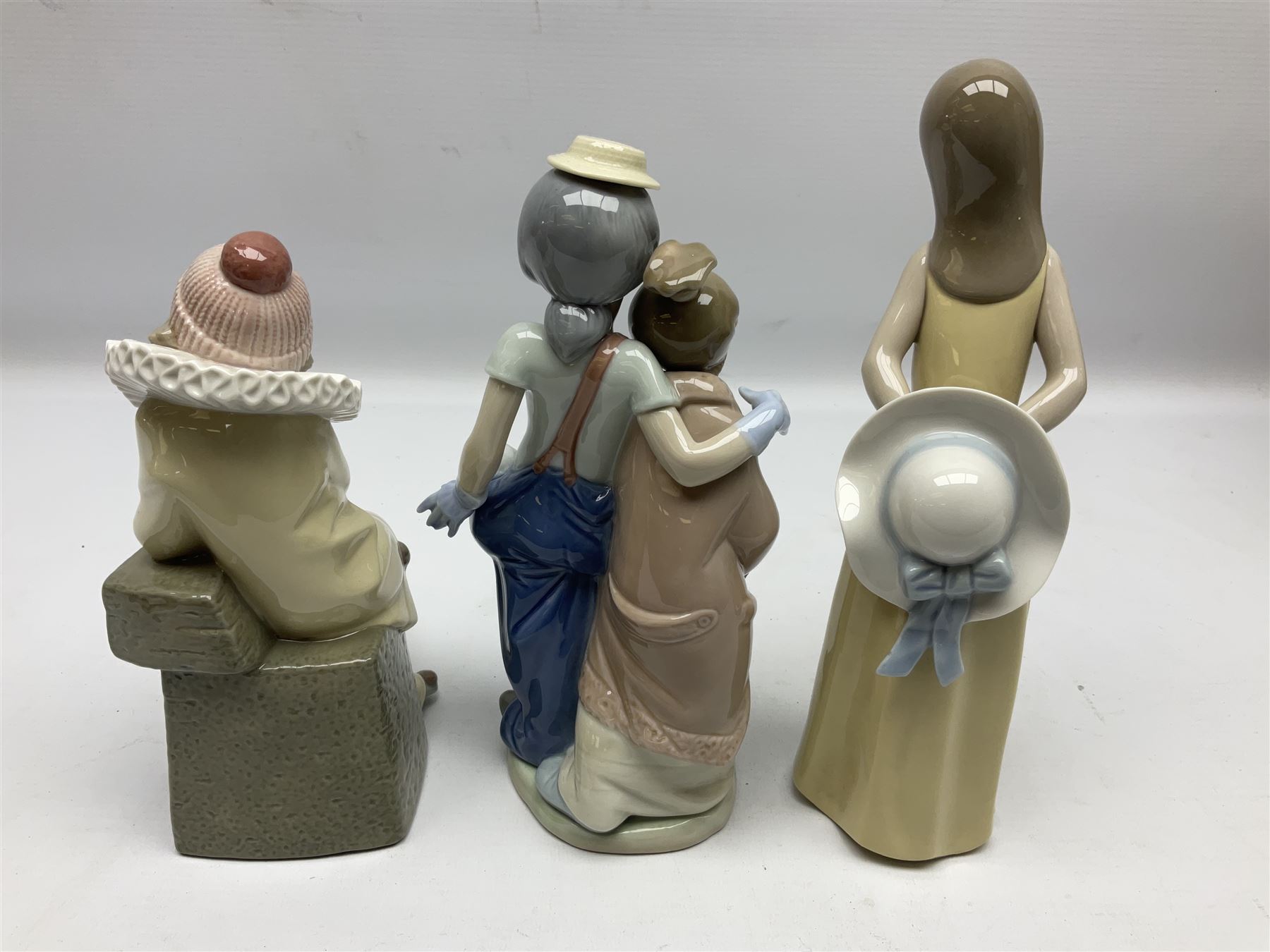 Three Lladro figures, comprising Little Jester no 5203, Pals Forever no 7686 and Naughty Girl no 5006, H25cm