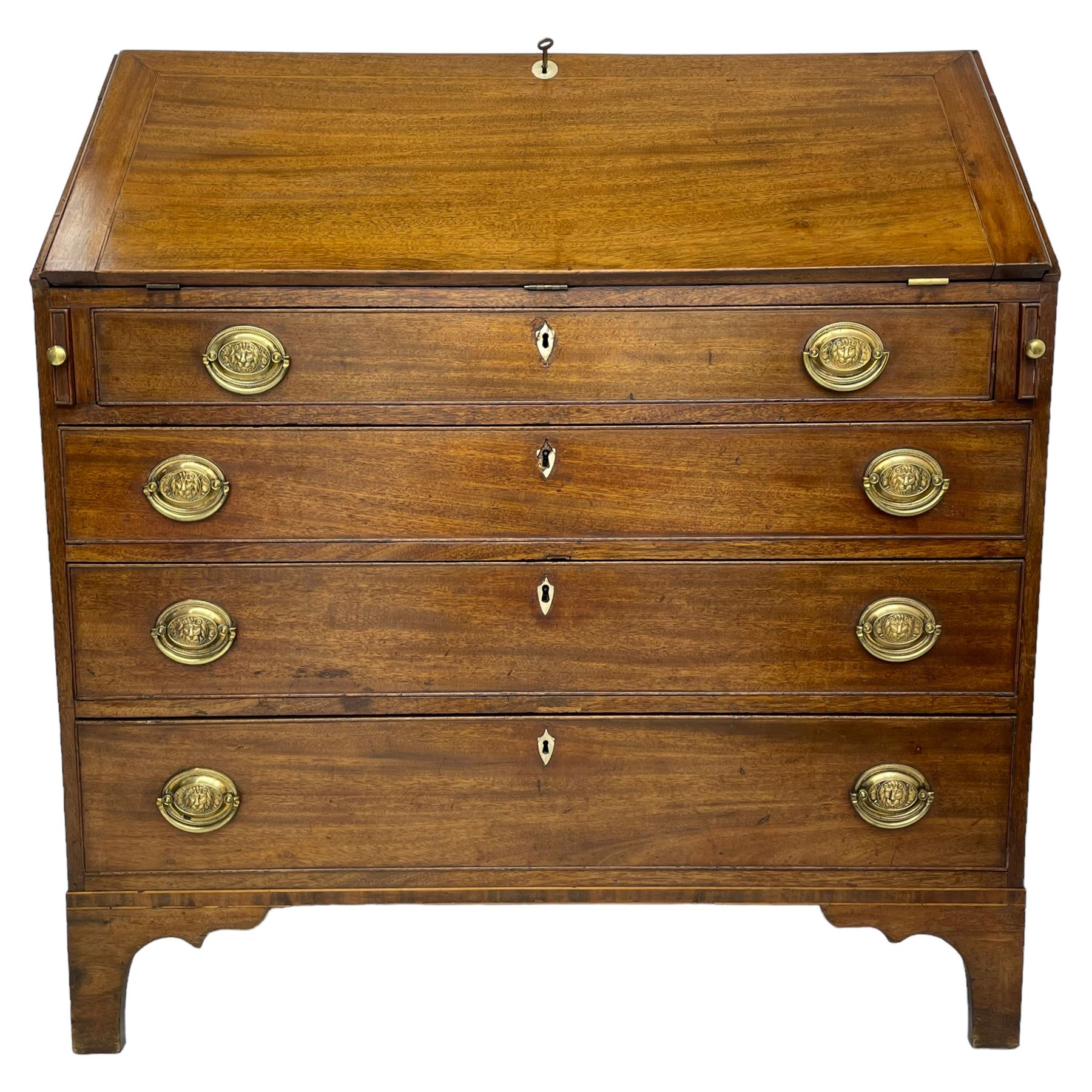 George III mahogany bureau, the fall-front banded and with boxwood stringing, enclosing fitted interior with pigeonholes and drawers surrounding a central cupboard with inlaid shell motif, the base with four graduating cock-beaded drawers, each with pressed brass handle plates with central lion masks and ivory escutcheons, on shaped bracket feet
This item has been registered for sale under Section 10 of the APHA Ivory Act