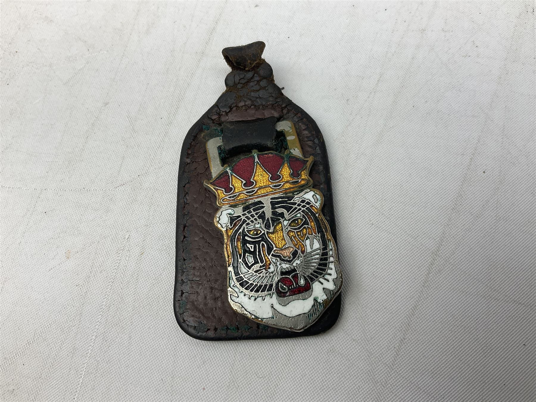 Leyland Royal Tiger enamelled metal sign of a tiger's head marked Manhattan Windsor Birmingham England no. NLH 960 to reverse, L16cm, together with a keyring and Leyland bus navy tie 