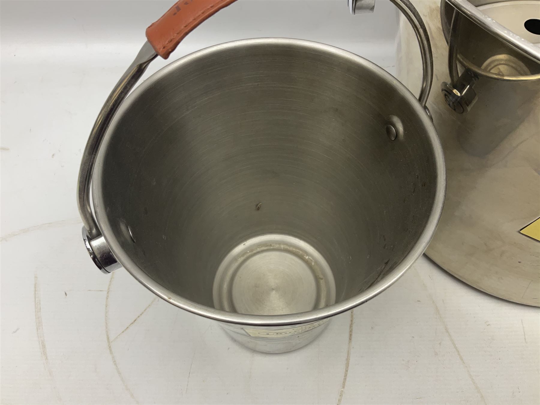 Stainless steel Laurent-Perrier champagne bucket, with engraved brass plaque and grip to swing handle, together with two matching smaller, largest D38cm (3)
