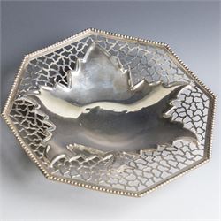 Indian silver dish, of octagonal form with central leaf decoration and pierced sides, upon...