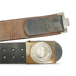 German WWI leather belt, the buckle marked 'Gott Mit Uns' surrounding a crown, a Third Reich webbing belt and buckle encircling eagle and swastika, NSDAP arm band and another