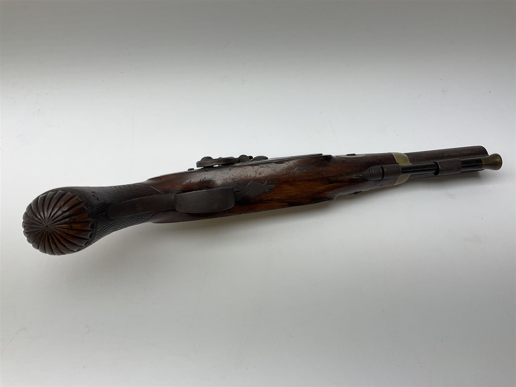 19th century flintlock converted to percussion cap target pistol, the 20.5cm barrel engraved with a sunburst motif to the top and ramrod under, foliate engraved lock-plate and trigger guard, silver plated fittings, walnut stock with chequered grip and melon fluted butt L35.5cm overall
