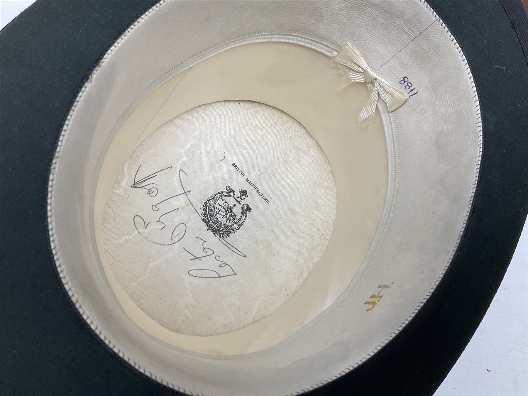 Leather hat box containing black felt top hat with 'British Manufacture' label, together with a grey top hat with 'Allens of Harrogate' label 