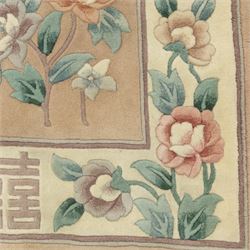 Chinese wool rug, beige ground decorated with peonies, flowering branches and butterflies, centred by a shou symbol within key pattern surround, cream border with floral sprays and double happiness motifs, cotton fringe ends