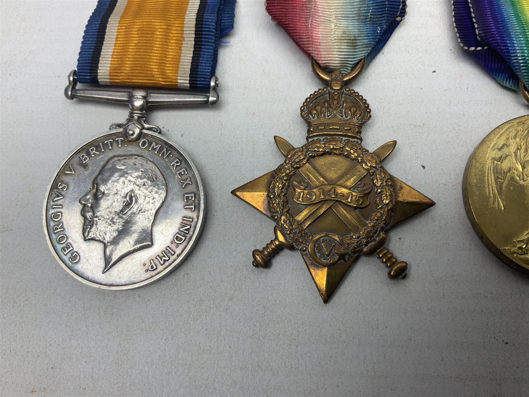 WW1 group of three medals comprising British War Medal, 1914-15 Star and Victory Medal awarded to 1781 Pte. W. Cartwright Manch. R.; and another WW1 British War Medal awarded to 30284 Pte. W.H. Paterson Manch. R.; all with ribbons (4)