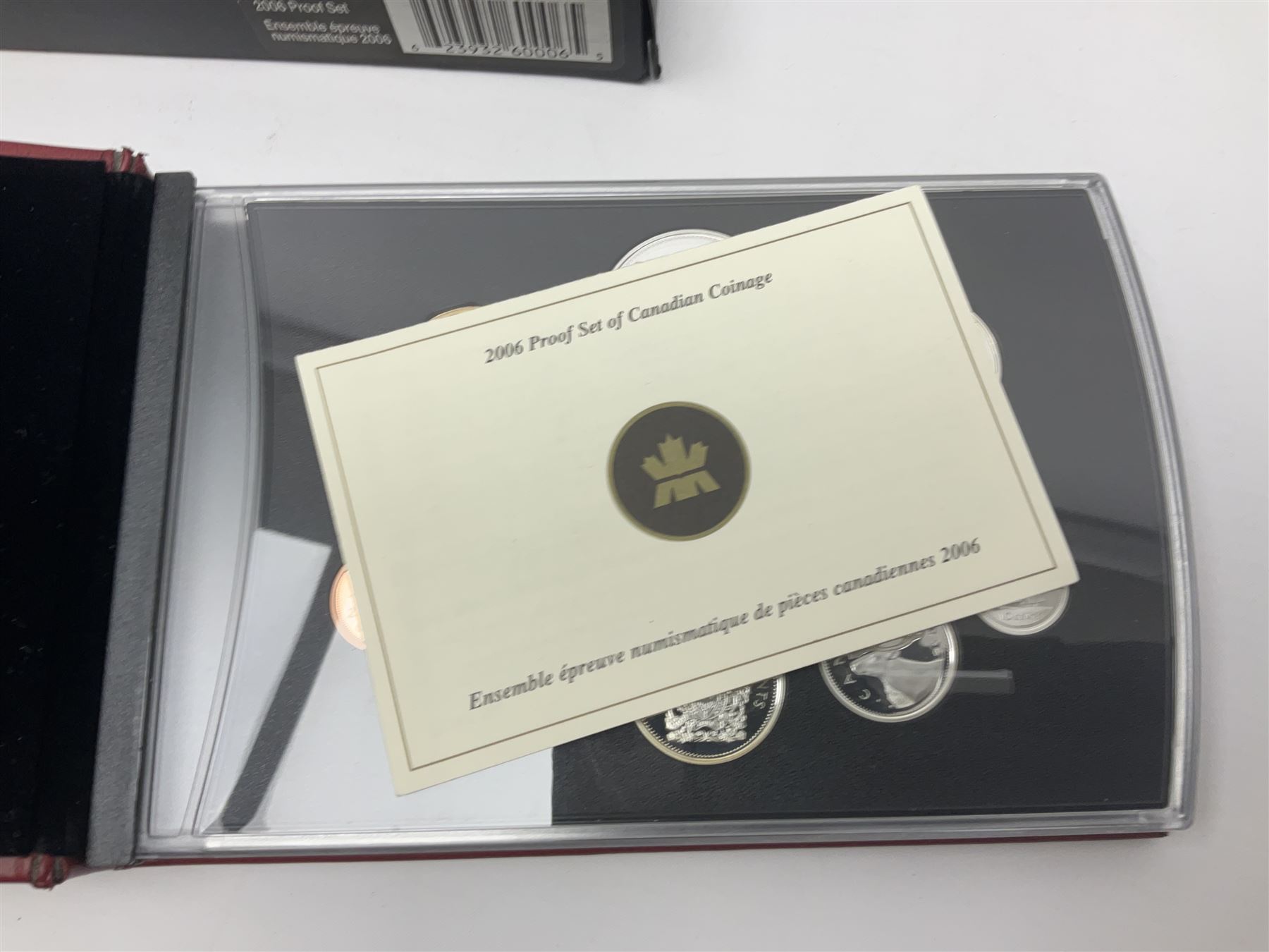 Queen Elizabeth II The Royal Canadian Mint 2006 silver proof dollar and two 2006 proof sets of Canadian coinage, all cased with certificates 