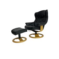 Anderssons of Sweden - mid-20th century design swivel armchair, upholstered black leather, raised on beech U-frame supports with circular base, together with matching footstool 