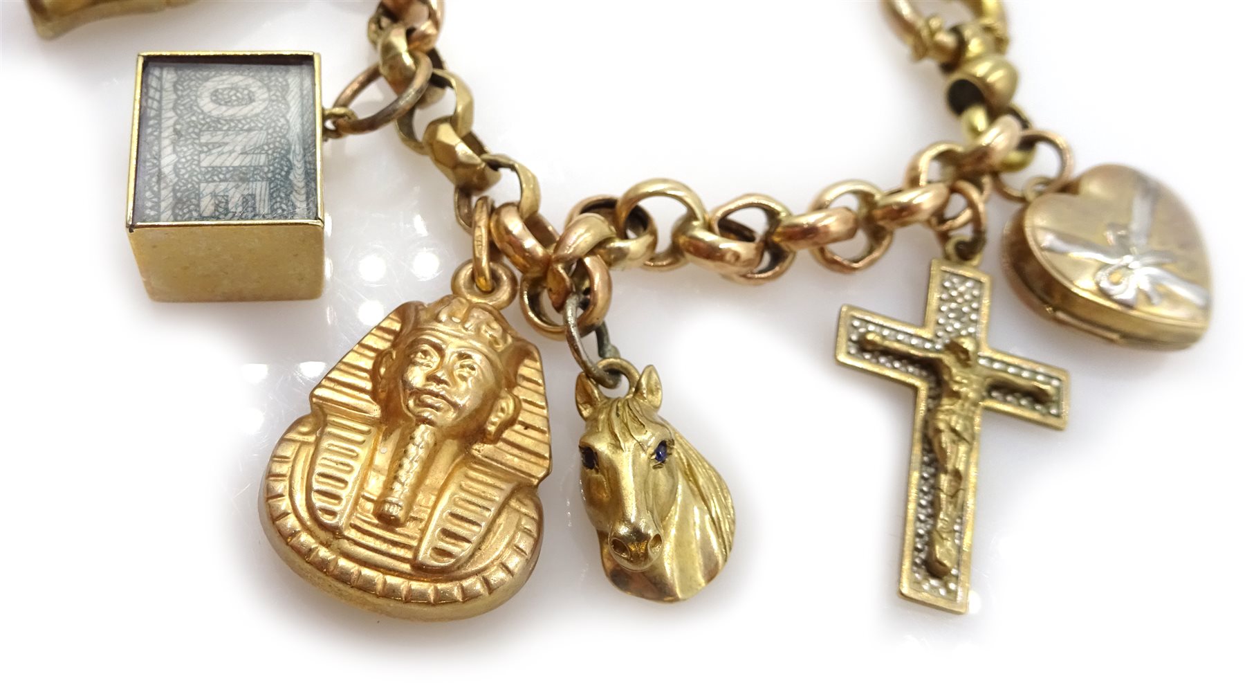 Gold belcher link bracelet with fourteen gold charms including ragdoll, clown, horse and money box, all 9ct hallmarked, tested or stamped
