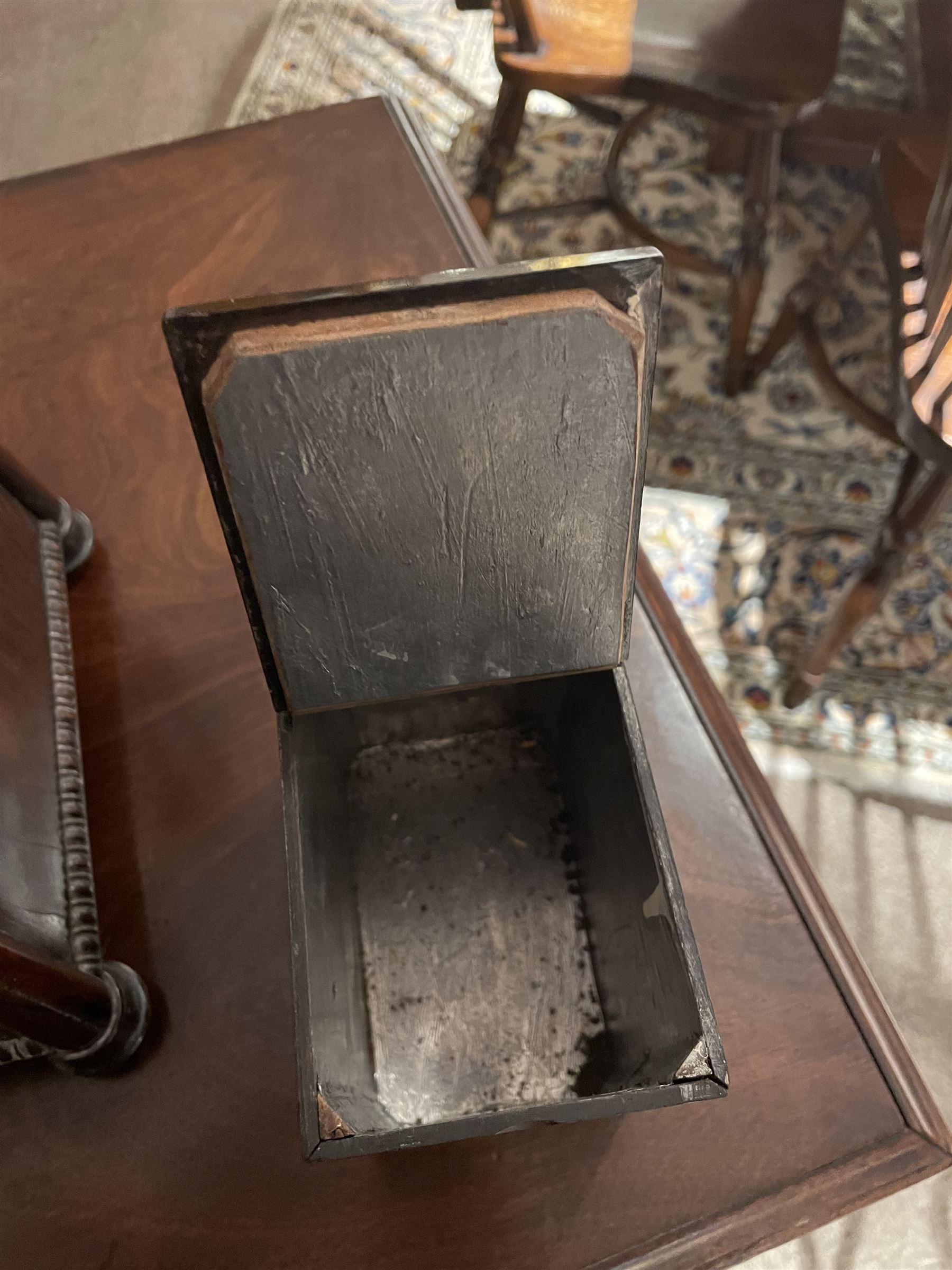 Early 19th century rosewood and brass inlaid tea caddy, of sarcophagus form, the front and hinged opening cover inlaid with brass scrolling panels, opening to reveal a compartmented interior with twin removable boxes with conforming inlaid brass detail to the hinged covers and zinc lining to the interiors, flanking a later glass mixing bowl, the whole upon four turned cylindrical feet, H21cm W36cm D20cm
