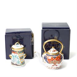 Collection of Royal Crown Derby miniature wares in Imari type patterns, comprising two champagne buckets with miniature champagne, milk churn, kettle, watering can, lawn roller, wheelbarrow, bench and kettle, five with boxes (10)